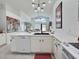 Modern kitchen with white cabinets, quartz countertops, and stainless steel appliances at 1309 Rebecca Dr, Haines City, FL 33844