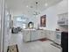 Modern kitchen featuring an island, white cabinets, modern lighting, and an open layout to the living area at 1309 Rebecca Dr, Haines City, FL 33844