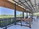 Relaxing outdoor dining area with golf course views, TV, covered patio and modern seating at 1309 Rebecca Dr, Haines City, FL 33844