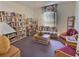 Cozy reading room with comfortable seating, floor to ceiling bookshelves, and natural light at 1309 Rebecca Dr, Haines City, FL 33844