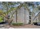 Three-story condo building with balconies and mature trees around the property at 1321 Arbor Vista Loop # 101, Lake Mary, FL 32746