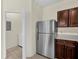 Kitchen space with stainless steel appliances and a doorway to laundry area at 1321 Arbor Vista Loop # 101, Lake Mary, FL 32746