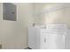 Bright laundry room with washer, dryer, and shelving unit at 1321 Arbor Vista Loop # 101, Lake Mary, FL 32746