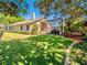 This backyard features a screened-in patio, lush lawn, and meticulous landscaping for outdoor enjoyment at 1450 Chessington Cir, Lake Mary, FL 32746