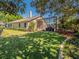 Expansive backyard showing lawn, decorative landscaping, screened-in patio, and exterior of the home at 1450 Chessington Cir, Lake Mary, FL 32746