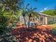 Well-maintained backyard featuring a screened-in patio, lawn furniture and palm trees at 1450 Chessington Cir, Lake Mary, FL 32746