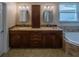 Double vanity with granite countertop and soaking tub offer relaxation and convenience at 1450 Chessington Cir, Lake Mary, FL 32746
