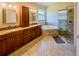 Spacious bathroom featuring a double vanity, bathtub and glass enclosed shower at 1450 Chessington Cir, Lake Mary, FL 32746