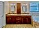 Double vanity bathroom with granite countertop, cabinetry and a window at 1450 Chessington Cir, Lake Mary, FL 32746
