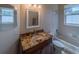 Bathroom with granite countertop, bathtub, and updated fixtures at 1450 Chessington Cir, Lake Mary, FL 32746