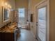 Bathroom features a marble countertop, a walk-in shower and an exit to the exterior at 1450 Chessington Cir, Lake Mary, FL 32746