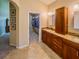 Bathroom with double vanity, closet, and tile flooring at 1450 Chessington Cir, Lake Mary, FL 32746