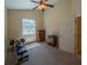 Bedroom featuring neutral walls, a ceiling fan, and neutral carpet with weights on the floor at 1450 Chessington Cir, Lake Mary, FL 32746