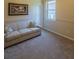 Cozy bedroom featuring neutral carpet and trim with natural light from a window at 1450 Chessington Cir, Lake Mary, FL 32746