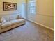 Cozy bedroom with neutral paint, carpet, and a sofa for additional seating at 1450 Chessington Cir, Lake Mary, FL 32746