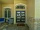 Elegant front entrance with double doors, tile flooring, and covered porch with seating at 1450 Chessington Cir, Lake Mary, FL 32746