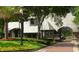 Charming Heathrow community gatehouse with lush landscaping and brick-paved entrance at 1450 Chessington Cir, Lake Mary, FL 32746