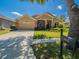 Well-manicured front yard with a charming home featuring a two-car garage and decorative landscaping at 1450 Chessington Cir, Lake Mary, FL 32746