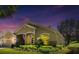 Charming single-story home with lush landscaping, beautiful lawn, and a welcoming facade with an American flag at 1450 Chessington Cir, Lake Mary, FL 32746