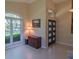 Entrance area with large windows, tile flooring, a desk, natural light, and a view of the stylish front door at 1450 Chessington Cir, Lake Mary, FL 32746