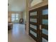 Bright foyer featuring ceramic floors, neutral walls, stylish front door, and view into the comfortable living room at 1450 Chessington Cir, Lake Mary, FL 32746