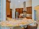 Modern kitchen featuring stainless steel appliances, granite counters, and wood cabinetry at 1450 Chessington Cir, Lake Mary, FL 32746