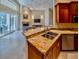 Open-concept kitchen with granite countertops and stainless steel sink, flowing into the living area at 1450 Chessington Cir, Lake Mary, FL 32746