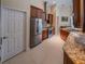 Well-equipped kitchen with stainless steel refrigerator, granite counters, and ample storage space at 1450 Chessington Cir, Lake Mary, FL 32746