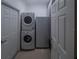 Efficient laundry room featuring a stacked washer and dryer, plus extra storage at 1450 Chessington Cir, Lake Mary, FL 32746