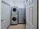 This laundry room features a stacked washer and dryer, plus a refrigerator for added convenience at 1450 Chessington Cir, Lake Mary, FL 32746