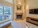 Bright living room with fireplace, tile floors, recessed lights and access to patio at 1450 Chessington Cir, Lake Mary, FL 32746