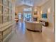 Bright living room with travertine floors, vaulted ceilings, fireplace, and access to the pool at 1450 Chessington Cir, Lake Mary, FL 32746