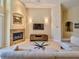 Open-concept living room with travertine floors, fireplace and natural light at 1450 Chessington Cir, Lake Mary, FL 32746