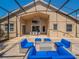 A covered lanai with stylish furniture offers a relaxing outdoor living space at 1450 Chessington Cir, Lake Mary, FL 32746