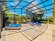 This covered patio features luxury outdoor lounge furniture and a view of the lush landscaping at 1450 Chessington Cir, Lake Mary, FL 32746