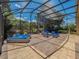 Open screened-in patio area with cozy seating and serene backyard views at 1450 Chessington Cir, Lake Mary, FL 32746