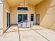 This covered patio features an outdoor dining area and a ceiling fan for comfortable gatherings at 1450 Chessington Cir, Lake Mary, FL 32746