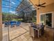 Spacious screened-in patio with comfortable outdoor furniture and a dining set at 1450 Chessington Cir, Lake Mary, FL 32746