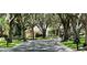 Tree-lined street view showcases well-manicured lawns and houses in the Heathrow community at 1450 Chessington Cir, Lake Mary, FL 32746