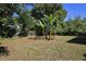 Lush backyard featuring tropical banana trees, providing a private and serene outdoor space at 1475 Lowrie Ave, Orlando, FL 32805
