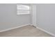 This bedroom features light tile floors, a closet, and a window with blinds at 1475 Lowrie Ave, Orlando, FL 32805