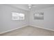 This bedroom features light tile floors and two windows with blinds at 1475 Lowrie Ave, Orlando, FL 32805