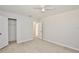 This bedroom features light tile floors, two closets, and a ceiling fan at 1475 Lowrie Ave, Orlando, FL 32805