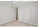 This bedroom features light tile floors, a closet, and ceiling fan at 1475 Lowrie Ave, Orlando, FL 32805