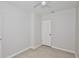 This bedroom features light tile floors, ceiling fan, and a white door at 1475 Lowrie Ave, Orlando, FL 32805