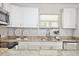 Well-lit kitchen featuring granite countertops, stainless steel appliances and tile backsplash at 1475 Lowrie Ave, Orlando, FL 32805