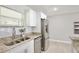 Bright kitchen showcasing granite countertops, stainless steel appliances and tile backsplash at 1475 Lowrie Ave, Orlando, FL 32805