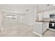 Open-concept living space with light gray walls, stylish floors and an eat-in kitchen bar at 1475 Lowrie Ave, Orlando, FL 32805