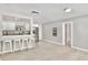 Open-concept living space with light gray walls, stylish floors and an eat-in kitchen bar at 1475 Lowrie Ave, Orlando, FL 32805