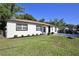 Exterior view of home showing updated exterior, windows and a well-manicured lawn at 1475 Lowrie Ave, Orlando, FL 32805